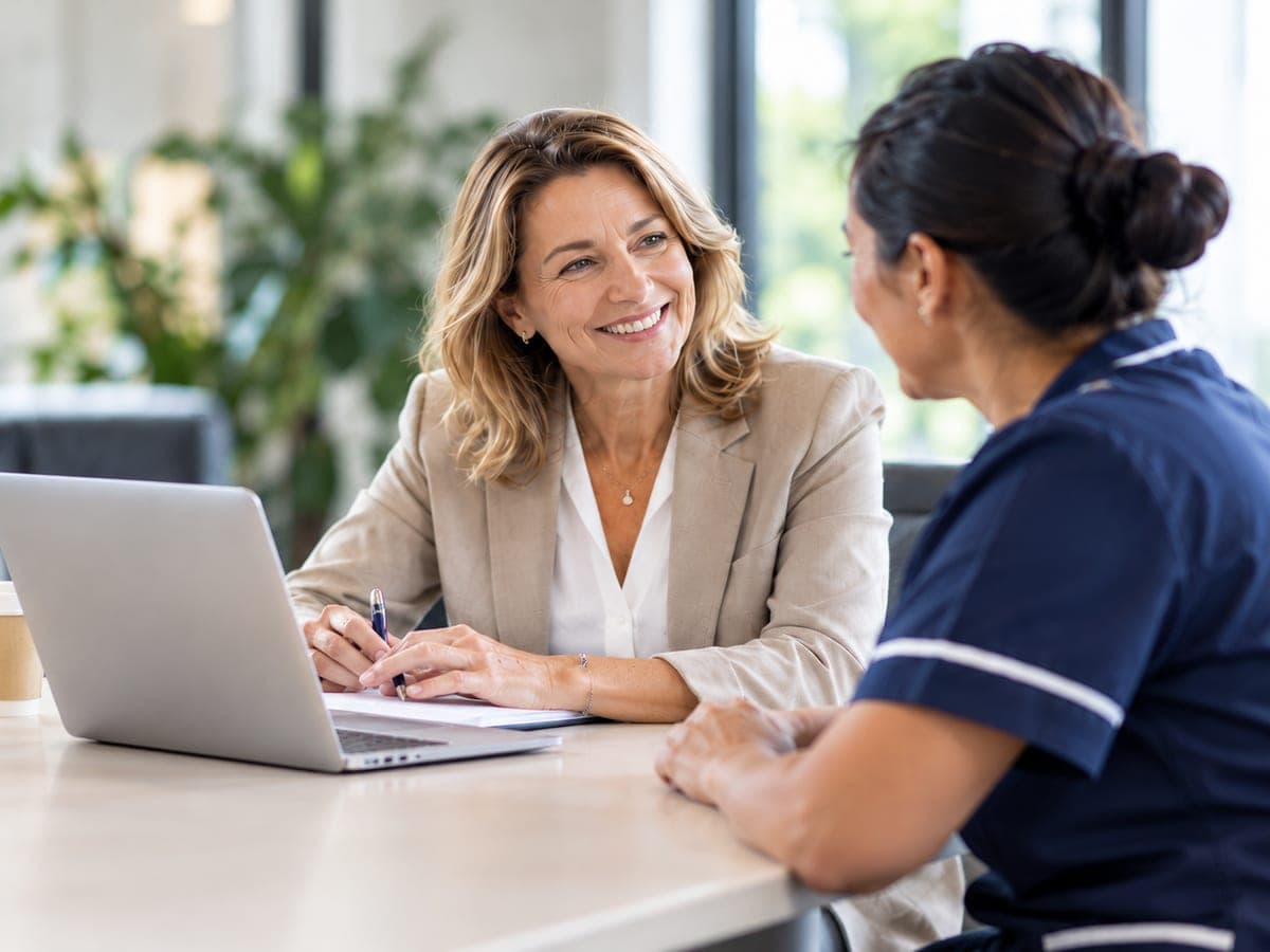 An executive and a nurse talking at a desk